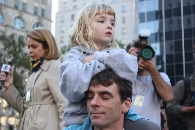 A young protester sits atop her father's shoulders at an Occupy Wall Street march in Foley Square in October